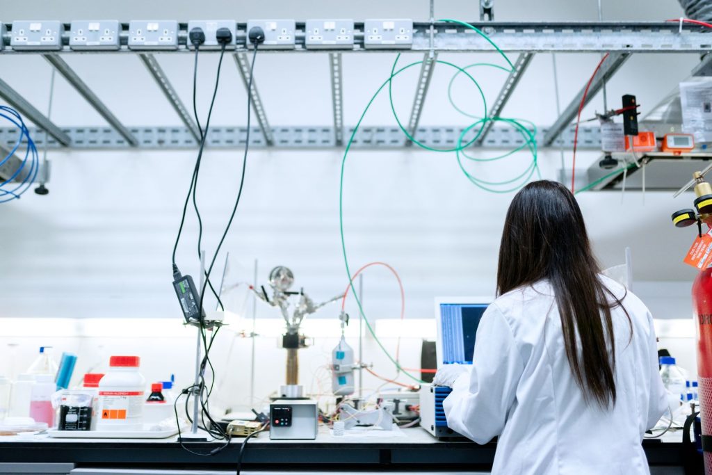 Pharmaceutical researcher working with digital laboratory equipment