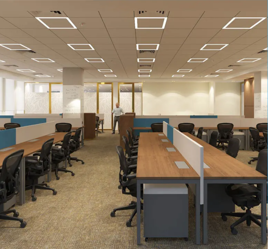 Open-plan office with rows of desks and chairs.