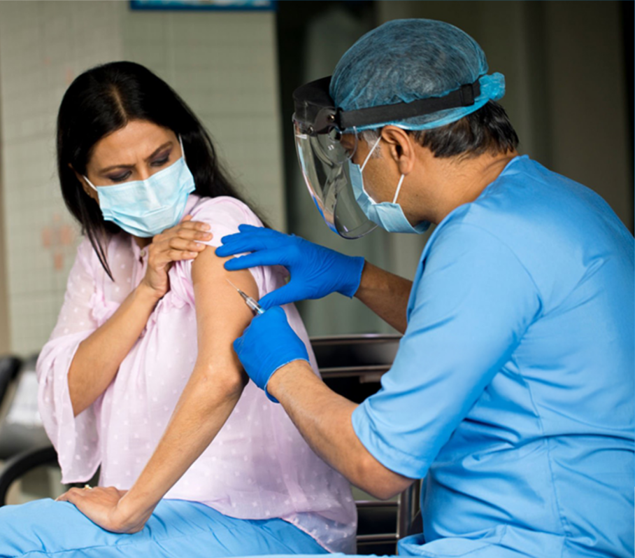 Healthcare worker administering a vaccination.